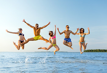 Image showing smiling friends in sunglasses on summer beach