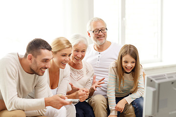 Image showing happy family watching tv at home