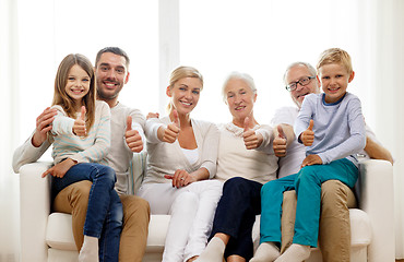 Image showing happy family sitting on couch at home