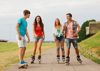 Image showing group of smiling teenagers with roller-skates