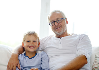 Image showing smiling grandfather and grandson at home