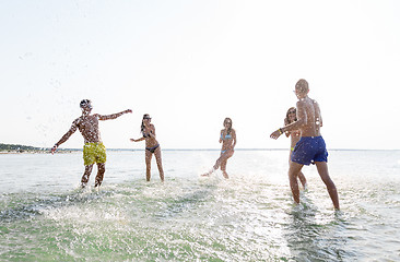 Image showing happy friends having fun on summer beach