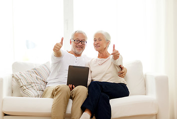 Image showing happy senior couple with tablet pc at home