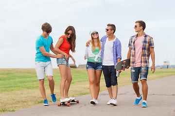 Image showing group of smiling teenagers with skateboards