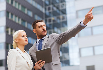 Image showing serious businessmen with tablet pc outdoors