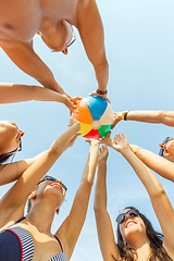 Image showing smiling friends in circle on summer beach