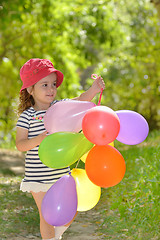 Image showing girl plays in summer park 