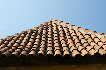 Image showing old tile roof on blue sky