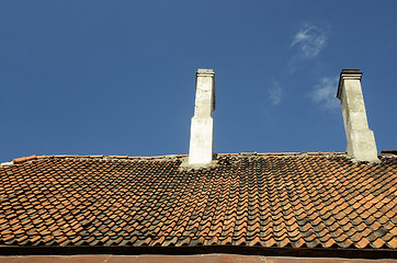 Image showing old tile roof on blue sky