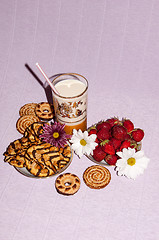 Image showing Strawberries milkshake and cookies