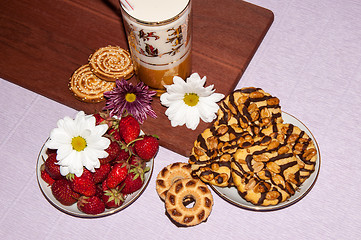 Image showing Strawberries milkshake and cookies