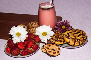 Image showing Strawberries milkshake and cookies