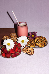 Image showing Strawberries milkshake and cookies