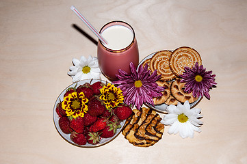 Image showing Strawberries milkshake and cookies,