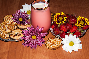 Image showing Strawberries milkshake and cookies,