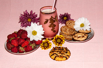 Image showing Strawberries milkshake and cookies,