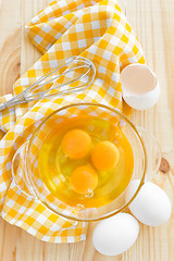 Image showing Raw eggs and whisk