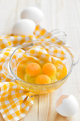 Image showing Raw eggs and whisk