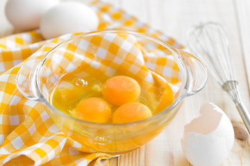 Image showing Raw eggs and whisk