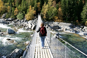 Image showing Woman on a suspension bridge