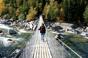 Image showing Woman on suspension bridge