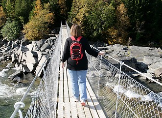 Image showing Woman on a suspension bridge