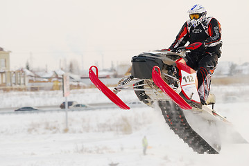 Image showing Sportsman on snowmobile on track