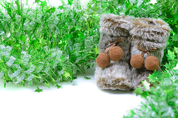 Image showing Green tinsel with snow boots decoration