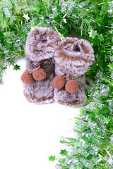 Image showing Snow boots with green tinsel