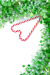 Image showing Green tinsel with candy canes decoration