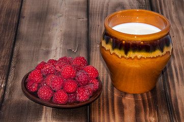 Image showing Ripe raspberry and milk jug 