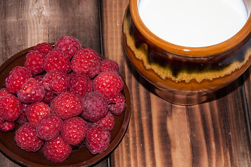 Image showing Ripe raspberry and milk jug 