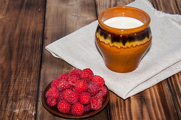 Image showing Ripe raspberry and milk jug 