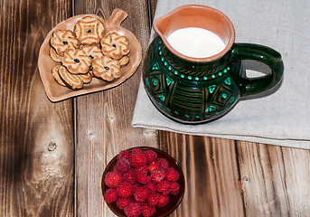 Image showing Ripe raspberry and milk jug 