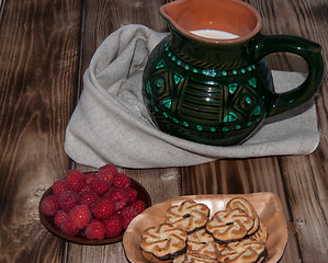 Image showing Ripe raspberry and milk jug 