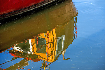 Image showing reflection of a boat in a port