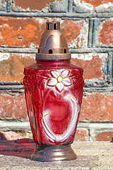 Image showing sanctuary lamp at a brickwall