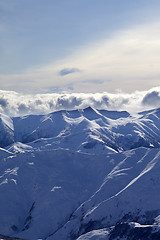 Image showing Snowy mountains and sunlight clouds at evening