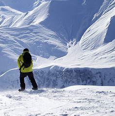 Image showing Snowboarder on top of off-piste slope at windy day