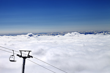 Image showing Mountains under clouds and chair-lift