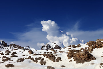 Image showing Snowy rocks and sky with clouds at nice day