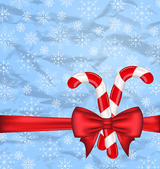 Image showing Christmas background with gift bow and sweet canes, snowflakes t