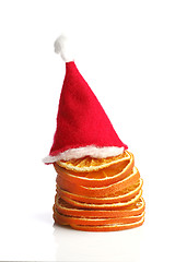 Image showing Red nicholas hat on top of dried oranges