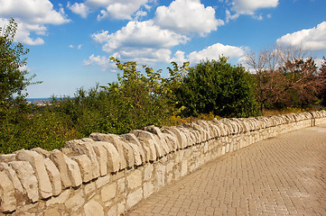 Image showing Stone wall sidewalk.