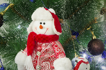 Image showing Amusing figure of a snowman on a Christmas fir-tree.