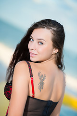 Image showing Portrait of smiling young brunette with tattoo