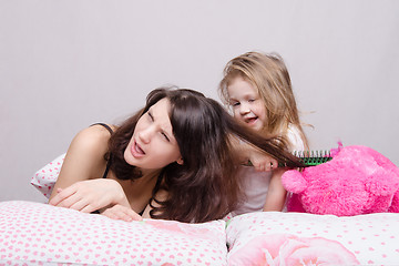 Image showing My mother is very sick. Daughter combing her hair