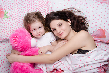 Image showing Mom and daughter lying in bed