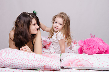 Image showing Girl combing her hair mom