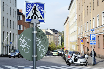 Image showing road signs with graffiti at a crossroads